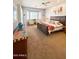 Cozy main bedroom with a seating area, large windows, and a neutral color scheme at 7024 W Tether Trl, Peoria, AZ 85383