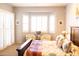 Bright main bedroom featuring shutters on the windows, chairs, and a decorative bed spread at 7024 W Tether Trl, Peoria, AZ 85383