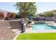 Beautiful backyard with an inviting pool, spa and lush desert landscape at 7024 W Tether Trl, Peoria, AZ 85383