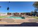 Lush backyard oasis with a sparkling pool and spa surrounded by vibrant plants at 7024 W Tether Trl, Peoria, AZ 85383