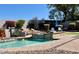 Backyard pool with landscaping, lounge chairs, and a rock waterfall feature for peaceful outdoor living at 7024 W Tether Trl, Peoria, AZ 85383