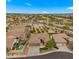 Wide aerial view showcasing homes with desert landscaping and mature trees, complete with sparkling swimming pool and spa at 7037 S Trophy Ln, Gilbert, AZ 85298