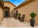 Cozy courtyard featuring a tiled patio, potted plants, and comfortable seating at 7037 S Trophy Ln, Gilbert, AZ 85298