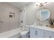 Modern bathroom has bathtub, shower, and white vanity with marble countertop at 7526 E Mckinley St, Scottsdale, AZ 85257