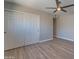 Neutral bedroom featuring wood-look tile flooring, a ceiling fan and closet with sliding doors at 7526 E Mckinley St, Scottsdale, AZ 85257