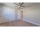 This bedroom features tile floors, a ceiling fan, and a spacious closet at 7526 E Mckinley St, Scottsdale, AZ 85257