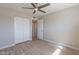 Neutral bedroom with a ceiling fan, wood-look flooring, and closet with sliding doors at 7526 E Mckinley St, Scottsdale, AZ 85257