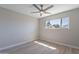 Bright bedroom featuring wood-look floors, a ceiling fan, and a large window at 7526 E Mckinley St, Scottsdale, AZ 85257