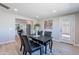 Dining area featuring a contemporary table, leading to the living room and kitchen areas at 7526 E Mckinley St, Scottsdale, AZ 85257