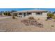 Inviting home exterior featuring desert landscaping, a carport, and a vibrant turquoise front door at 7526 E Mckinley St, Scottsdale, AZ 85257