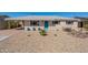 Charming home exterior with low maintenance desert landscaping, a carport, and a turquoise front door at 7526 E Mckinley St, Scottsdale, AZ 85257