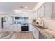Bright, renovated kitchen featuring white cabinets, subway tile backsplash, and stainless steel appliances at 7526 E Mckinley St, Scottsdale, AZ 85257