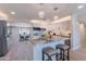 Modern, bright kitchen with white cabinetry, a center island with seating, and stainless steel appliances at 7526 E Mckinley St, Scottsdale, AZ 85257