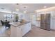 Bright kitchen with island, stainless refrigerator, and open flow to the living area at 7526 E Mckinley St, Scottsdale, AZ 85257