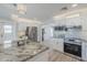 Spacious kitchen with island, stainless appliances, and easy access to dining and living areas at 7526 E Mckinley St, Scottsdale, AZ 85257