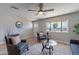 Bright living room with a large window, comfortable seating, ceiling fan, and stylish decor at 7526 E Mckinley St, Scottsdale, AZ 85257