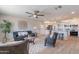 Open-concept living room leading to a modern kitchen, with stylish furniture and a ceiling fan at 7526 E Mckinley St, Scottsdale, AZ 85257