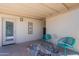 Cozy covered patio with blue accent chairs, and a lovely rug at 7526 E Mckinley St, Scottsdale, AZ 85257