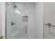 The tiled shower has a glass door and a uniquely tiled inset at 7526 E Mckinley St, Scottsdale, AZ 85257