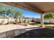 Covered patio with string lights overlooking a backyard featuring mature landscaping and a rock garden at 770 W Kent Pl, Chandler, AZ 85225