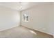 Bright bedroom featuring neutral carpet, a window and chandelier lighting at 770 W Kent Pl, Chandler, AZ 85225