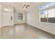 Bright living room featuring modern light fixtures, tile flooring, and arched windows at 770 W Kent Pl, Chandler, AZ 85225