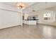 Open living room flowing into kitchen, featuring tile floors, modern lighting, and ample space at 770 W Kent Pl, Chandler, AZ 85225