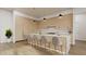 A modern kitchen features an island with seating, sleek cabinets, hardwood floors, and contemporary pendant lighting at 8233 E Camino Adele --, Scottsdale, AZ 85255