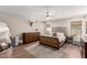 Well-lit bedroom with a neutral color scheme, a large bed, and wood flooring at 8807 E Dahlia Dr, Scottsdale, AZ 85260