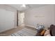 Bedroom with sleeper sofa, neutral carpet, and decorative rug at 8807 E Dahlia Dr, Scottsdale, AZ 85260
