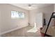 Bedroom with large window, wardrobe, neutral paint, and neutral carpet at 8807 E Dahlia Dr, Scottsdale, AZ 85260