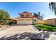 Charming two-story home with a red tile roof, a spacious driveway, and well-maintained landscaping at 8807 E Dahlia Dr, Scottsdale, AZ 85260