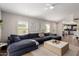 Bright living room with wood floors, a large couch, and a ceiling fan at 8807 E Dahlia Dr, Scottsdale, AZ 85260