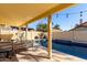 Inviting pool area with a covered patio, string lights, and outdoor seating, perfect for relaxation at 8807 E Dahlia Dr, Scottsdale, AZ 85260