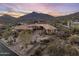 Luxury desert home features a sprawling driveway and beautiful natural landscaping with mature cacti and desert foliage at 9920 E Honey Mesquite Dr # 155, Scottsdale, AZ 85262