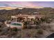 Aerial view of a luxurious home with a pool and outdoor seating nestled in a desert landscape at 9920 E Honey Mesquite Dr # 155, Scottsdale, AZ 85262