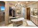 Luxurious bathroom featuring a freestanding tub, mirrored wall, and elegant chandelier at 9920 E Honey Mesquite Dr # 155, Scottsdale, AZ 85262