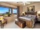 A bedroom featuring wood furnishings, and scenic views of the desert landscape through a large picture window at 9920 E Honey Mesquite Dr # 155, Scottsdale, AZ 85262