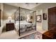 Elegant bedroom features four-poster bed, carpet, and decorative furniture at 9920 E Honey Mesquite Dr # 155, Scottsdale, AZ 85262