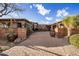 Impressive gated driveway with paver stones leading to an estate home surrounded by desert landscaping at 9920 E Honey Mesquite Dr # 155, Scottsdale, AZ 85262