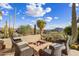 Inviting outdoor firepit with seating area surrounded by lush desert landscaping at 9920 E Honey Mesquite Dr # 155, Scottsdale, AZ 85262