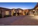 Beautiful single-story home with desert landscaping and an arched entrance at dusk at 9920 E Honey Mesquite Dr # 155, Scottsdale, AZ 85262