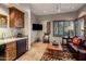 The living room has a wet bar, wood shutters, entertainment area, and decorative trunk coffee table at 9920 E Honey Mesquite Dr # 155, Scottsdale, AZ 85262