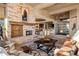 Spacious living room with a stone fireplace, coffered ceilings, and an open layout at 9920 E Honey Mesquite Dr # 155, Scottsdale, AZ 85262