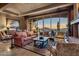 Elegant living room showcasing a wall of windows with stunning mountain views at sunset at 9920 E Honey Mesquite Dr # 155, Scottsdale, AZ 85262