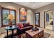 Cozy living room features wood shutters, leather sofa, and decorative trunk coffee table at 9920 E Honey Mesquite Dr # 155, Scottsdale, AZ 85262