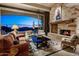 Comfortable living room with a stone fireplace and expansive views of the backyard at 9920 E Honey Mesquite Dr # 155, Scottsdale, AZ 85262