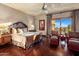 Elegant main bedroom with hardwood floors, decorative curtains, and private balcony access at 9920 E Honey Mesquite Dr # 155, Scottsdale, AZ 85262