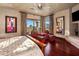 Comfortable main bedroom featuring hardwood floors, balcony access, and seating area with chairs at 9920 E Honey Mesquite Dr # 155, Scottsdale, AZ 85262