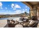 Spacious covered patio with comfortable seating overlooking the inviting pool and mountain views at 9920 E Honey Mesquite Dr # 155, Scottsdale, AZ 85262